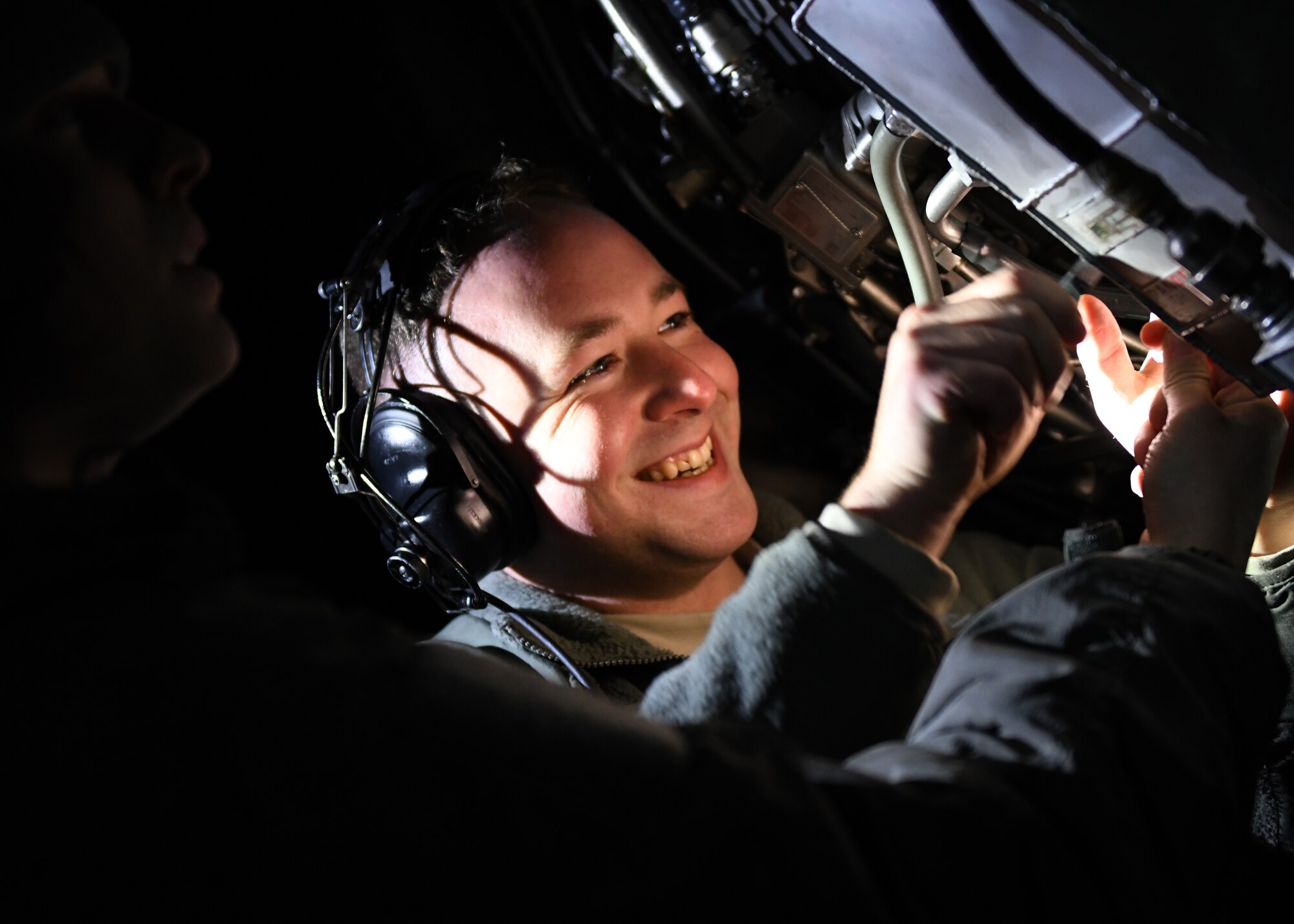 Senior Airman Zachary Rogers, a 28th Aircraft Maintenance Squadron aerospace propulsion journeyman, smiles as he performs maintenance on a grounded B-1B Lancer at Ellsworth Air Force Base, S.D., Dec. 4, 2018. Aerospace propulsion, hydraulic systems, crew chiefs and avionics all work together in their area of expertise to ensure the aircraft is properly maintained and ready to fly. (U.S. Air Force photo by Senior Airman Denise Jenson)