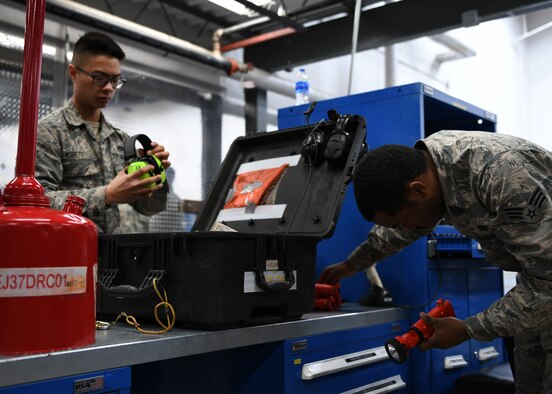 Airman 1st Class Alexander Moreto, a 28th Aircraft Maintenance Squadron hydraulic systems apprentice, left, inspects a tool kit prior to checking it out during a shift change at Ellsworth Air Force Base, S.D., Dec. 4, 2018. Tool kits are inspected to ensure every piece is intact when it is checked out and returned. (U.S. Air Force photo by Senior Airman Denise Jenson)