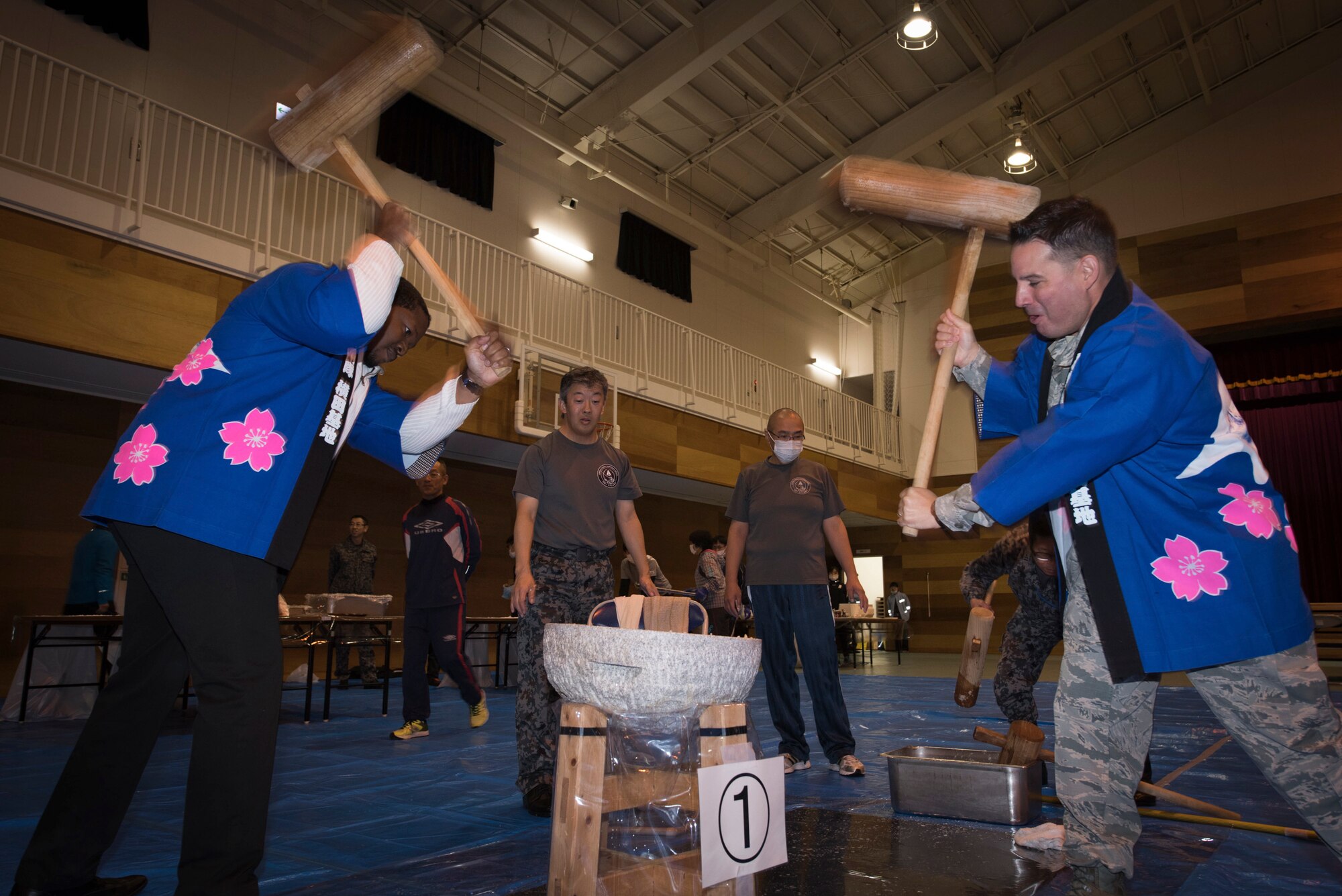 (Right to Left) Col. Sergio Vega, 374th Airlift Wing vice commander, and Jay Brown, Department of Defense Special Representative Japan director, pound steamed rice to make rice cakes during a rice pounding event hosted by Japan Air Self-Defense Force’s Operations Support Wing at Yokota Air Base, Japan, Dec. 12, 2018.