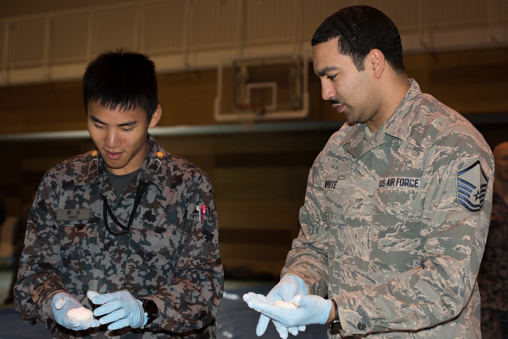 Master Sgt. Milton White, 374th Communications Squadron project manager, wraps anko (sweet red bean paste) with rice cake during a rice pounding event hosted by Japan Air Self-Defense Force at Yokota Air Base, Japan, Dec. 12, 2018.