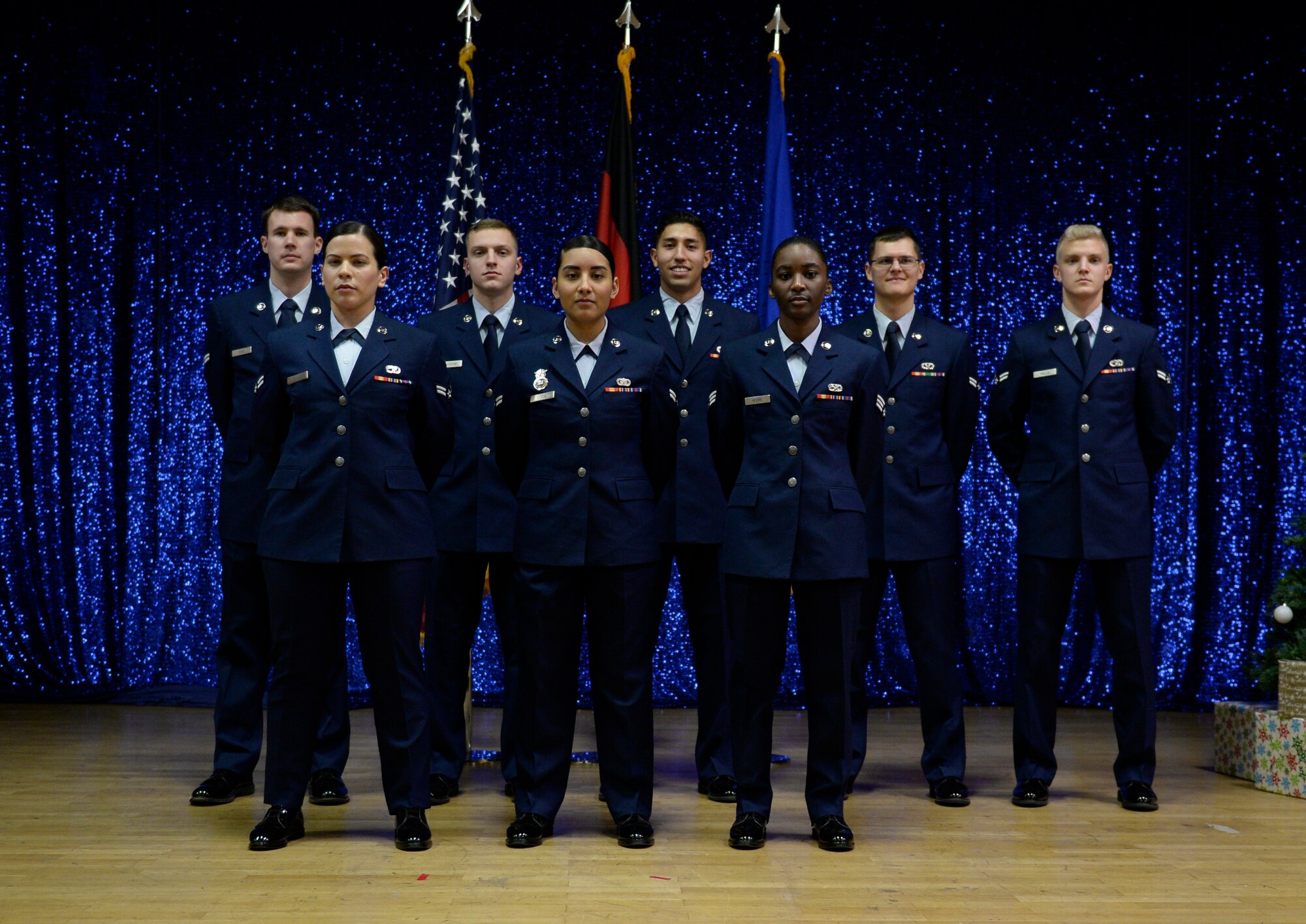 Airmen from Honor Guard Class 18-D pose after graduation at the Community Center on Spangdahlem Air Base, Germany, December 7, 2018. Airmen from the 52nd Fighter Wing and 86th Airlift Wing, Ramstein AB, trained on more than 60 variations of facing and drill movements during the week long training. (U.S. Air Force photo by Senior Airman Dawn M. Weber)