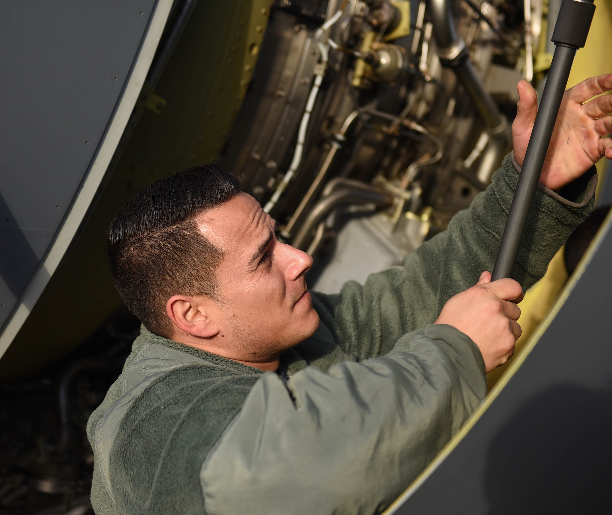 U.S. Air Force Tech. Sgt. Torrey Sanchez, 100th Aircraft Maintenance Squadron aerospace propulsion lead technician, closes a hatch on a KC-135 Stratotanker engine at RAF Mildenhall, England, Nov. 30, 2018. The aerospace propulsion shop maintains the engines, as well as conducts periodic inspections and unscheduled maintenance. (U.S. Air Force photo by Senior Airman Luke Milano)