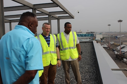 James Wilkerson, lead logistics management specialist for LOGCAP Africa (left), U.S. Army Col. Grant L. Morris, commander 405th Army Field Support Brigade (middle), U.S. Army Command Sgt. Maj. James R. Holmes III, 405th AFSB (right) look on to the West African Logistics Network hub at Accra, Ghana on Dec. 1. The day marked the WALN’s first day of full operative capability, The WALN is a regional aerial distribution concept with spokes that allows to receive passenger and cargo.