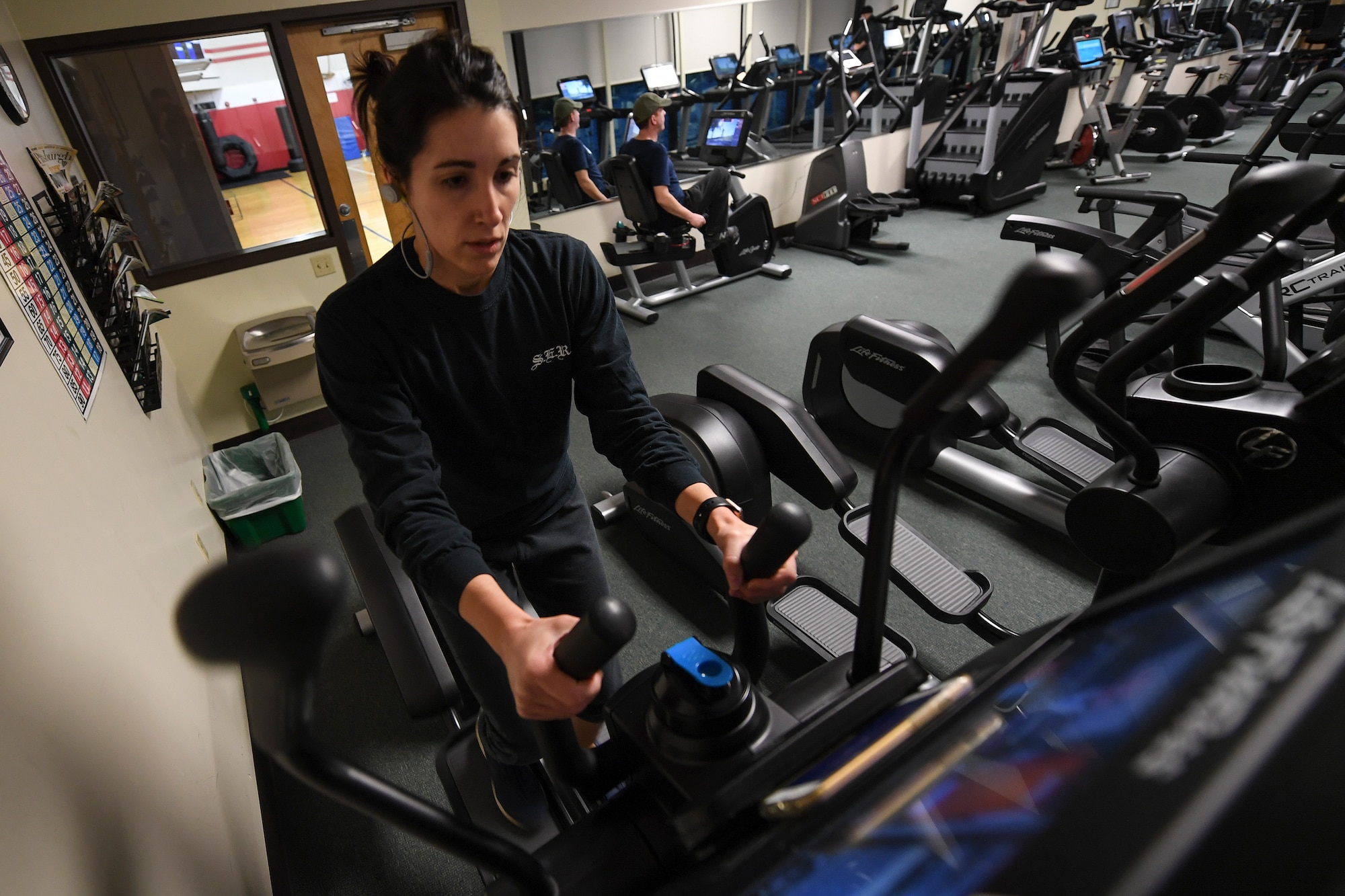 Angela Montgomery, secretary for the 911th Mission Support Group, and Robert Ree, director of the 911th Airman Family Readiness Center, exercise using fitness center equipment at Pittsburgh IAP ARS, Pennsylvania, December 11, 2018. The 911th Airlift Wing Fitness Center recently replaced older cardio equipment with brand new equipment at the end of November, including seven elliptical trainers, six new treadmills, four stationary bicycles and a brand new Arc Trainer. (U.S. Air Force photo by Joshua J. Seybert)