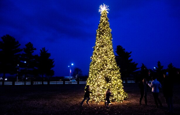 Staff Sgt. Joseph Tharp, 375th Operational Support Squadron aircrew flight equipment technician, and his family take photos near the Scott Event Center tree during the Holiday Party and Tree Lighting Ceremony, Dec. 7, 2018, at Scott Air Force Base, Illinois. “The most memorable moment was seeing the kids’ faces light up when Santa and Mrs. Claus walked through the door,” said Tharp.