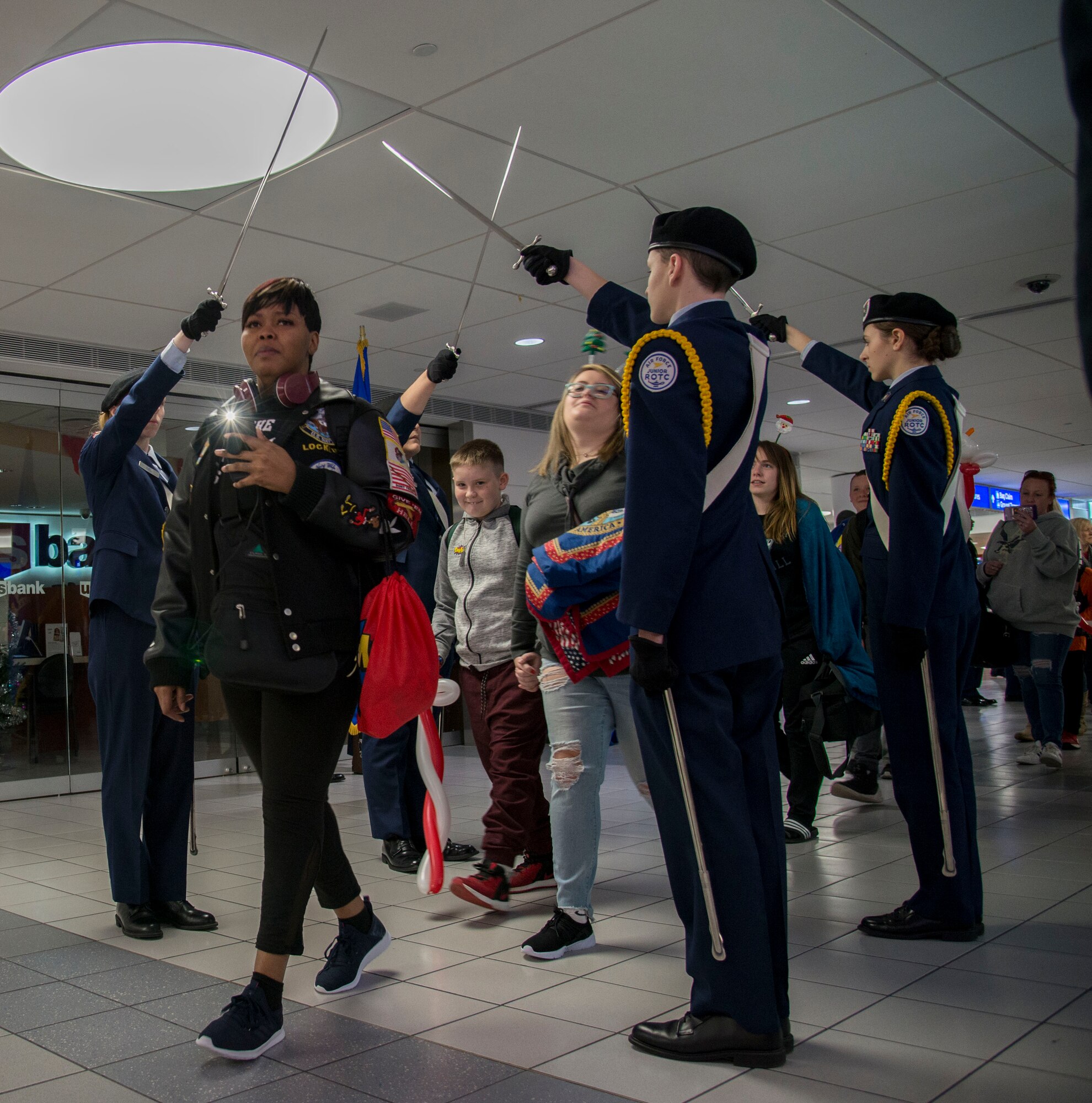 Students from the Alton High School JROTC program salute Gold Star families as they as they start their four day trip to Disney World as part of the Snow Ball Express Dec. 8, 2018 at the St. Louis-Lambert airport in St. Louis, Missouri.