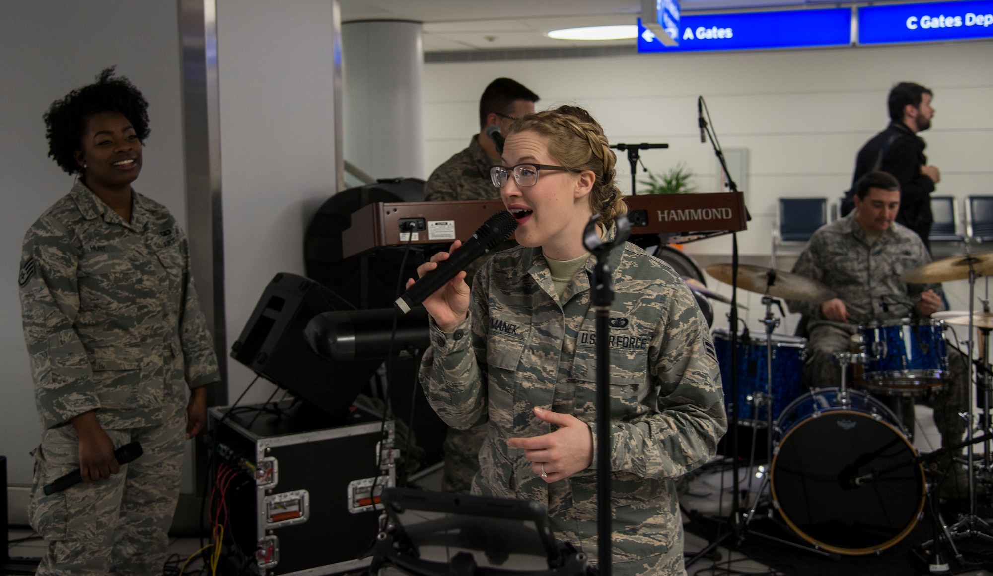 The band Starlifter, part of the Band of Mid-America, performs for Gold Star families during the Snow Ball Express at the St. Louis-Lambert airport, Dec. 8, 2018, in St. Louis, Missouri. The Snow Ball Express is an event organized to give Gold Star families a four-day trip to Disney World in Orlando, Florida. The trip is sponsored by the Gary Sinise Foundation and American Airlines.