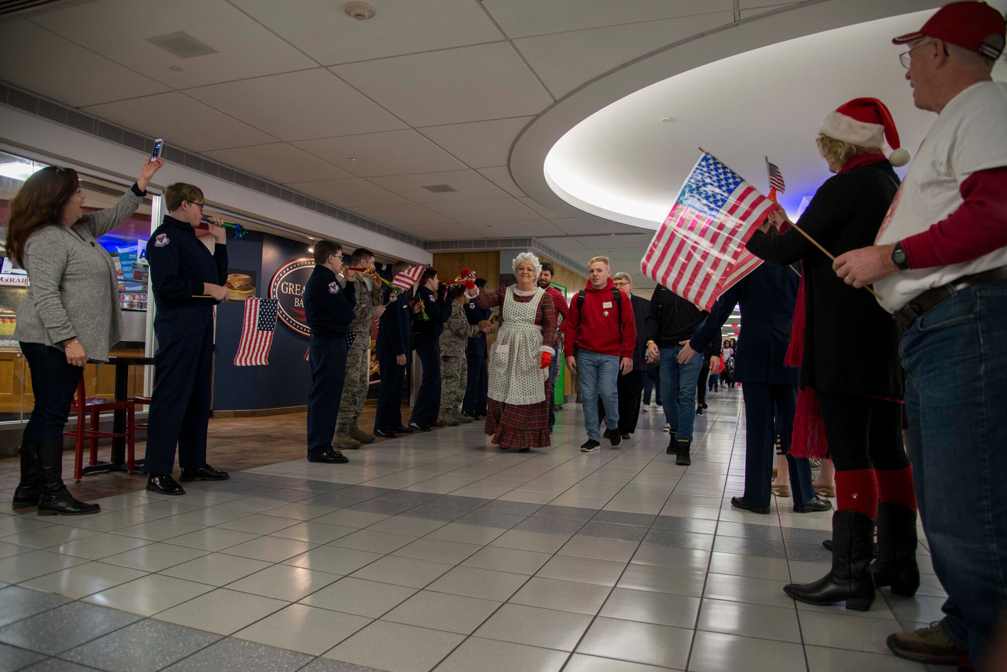 Gold Star families are cheered on as they enter the St. Louis-Lambert airport Dec. 8, 2018 in St. Louis, Missouri. Families from all over the country were flown to Disney World in Orlando, Florida, as part of the Snow Ball Express, a four-day trip sponsored by the Gary Sinise Foundation and American Airlines to honor Gold Star families.