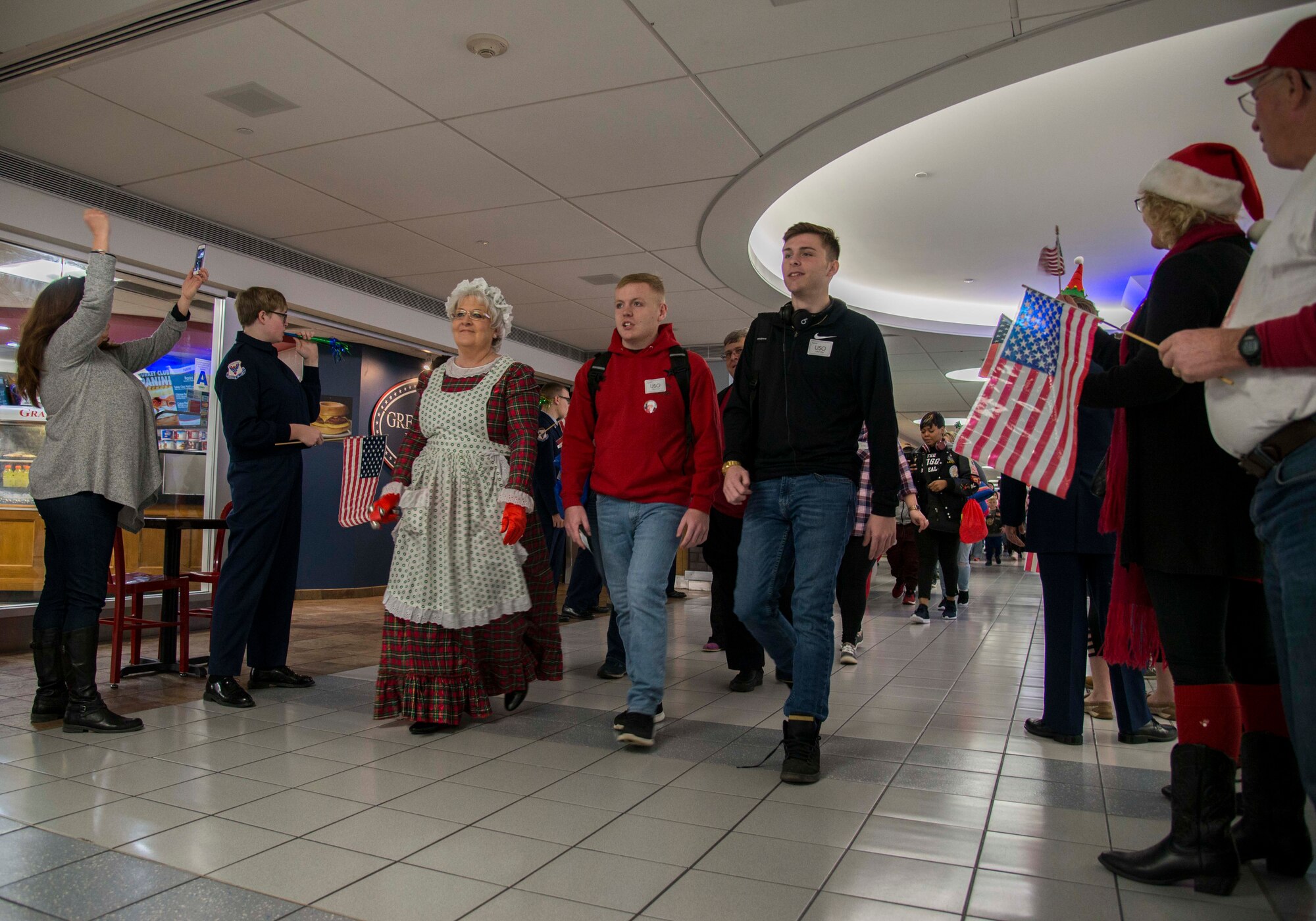 Gold Star families are cheered on as they enter the St. Louis-Lambert airport Dec. 8, 2018 in St. Louis, Missouri. Families from all over the country were flown to Disney World in Orlando, Florida, as part of the Snow Ball Express, a four-day trip sponsored by the Gary Sinise Foundation and American Airlines to honor Gold Star families.