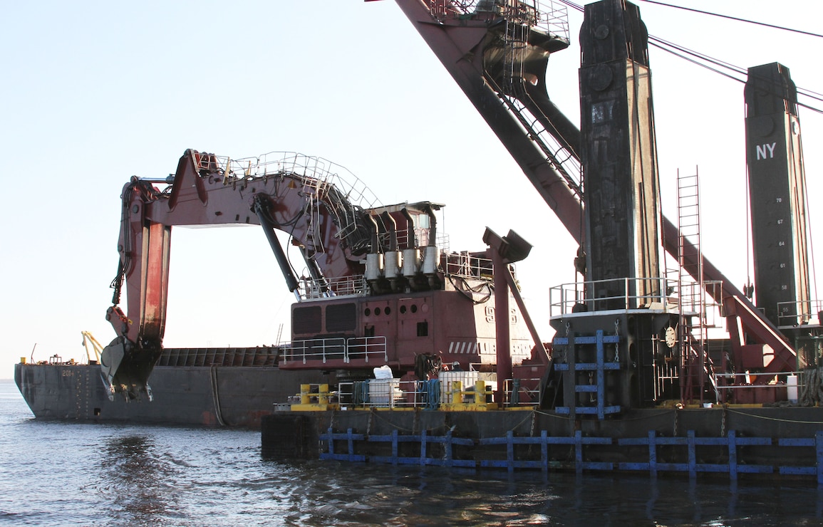 The mechanical dredge NEW YORK, owned and operated by Great Lakes Dredge & Dock Company, removes rock material from the Delaware River as part of the project to deepen the channel from 40 to 45 feet. The project is a joint effort between USACE and the Port of Philadelphia. The deeper channel will provide for more efficient transportation of cargo to and from Delaware River ports.