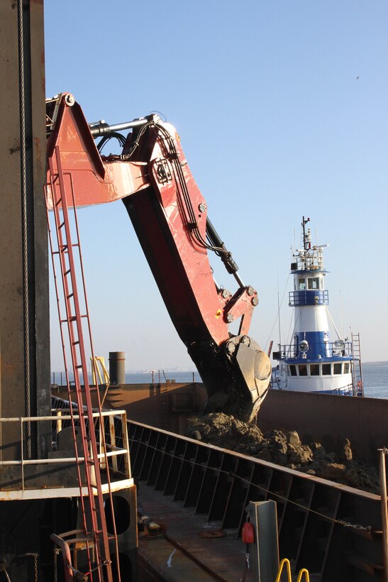 The mechanical dredge NEW YORK, owned and operated by Great Lakes Dredge & Dock Company, loads rock onto a barge as part of the project to deepen the Delaware River channel from 40 to 45 feet. The project is a joint effort between USACE and the Port of Philadelphia. The deeper channel will provide for more efficient transportation of cargo to and from Delaware River ports.