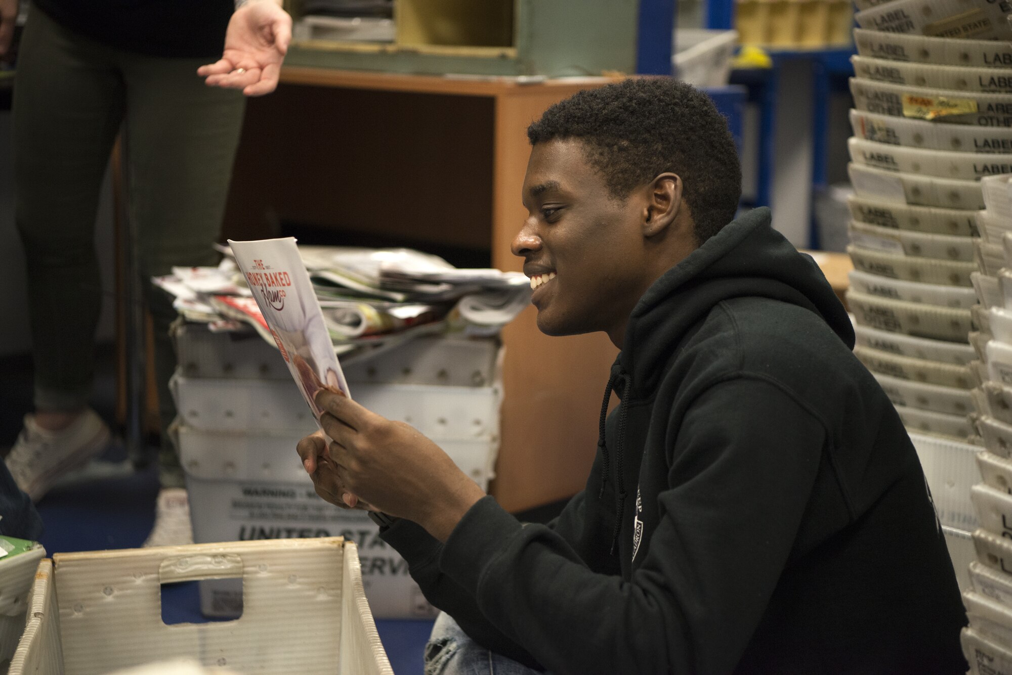 U.S. Air Force Airman 1st Class Exzavier Stevenson, a member of the 450th Intelligence Squadron, sorts mail at the North Side Post Office on Ramstein Air Base, Germany, Dec. 7, 2018. The 450th IS War-Bird Service Day imparts the importance of volunteerism to its Airmen. (U.S. Air Force Photo by Airman 1st Class Noah Coger)