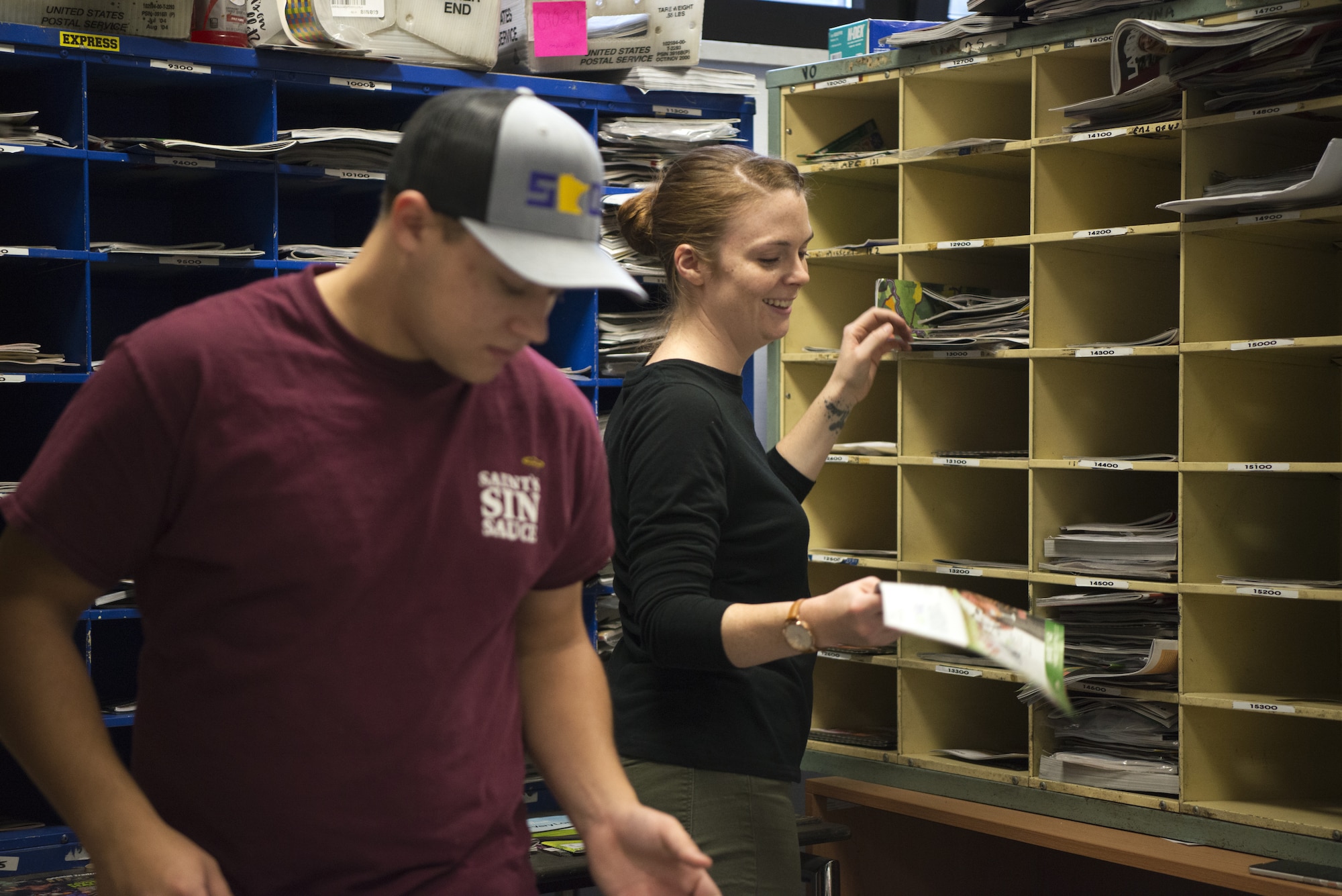 U.S. Air Force Airman 1st Class Taylor Greenwalt, left, and Staff Sgt. Emily Luzum, right, 450th Intelligence Squadron Airmen, sort mail at the North Side Post Office on Ramstein Air Base, Germany, Dec. 7, 2018. The 450th IS eased increased volume the holidays bring to the post offices on Ramstein Air Base. (U.S. Air Force Photo by Airman 1st Class Noah Coger)