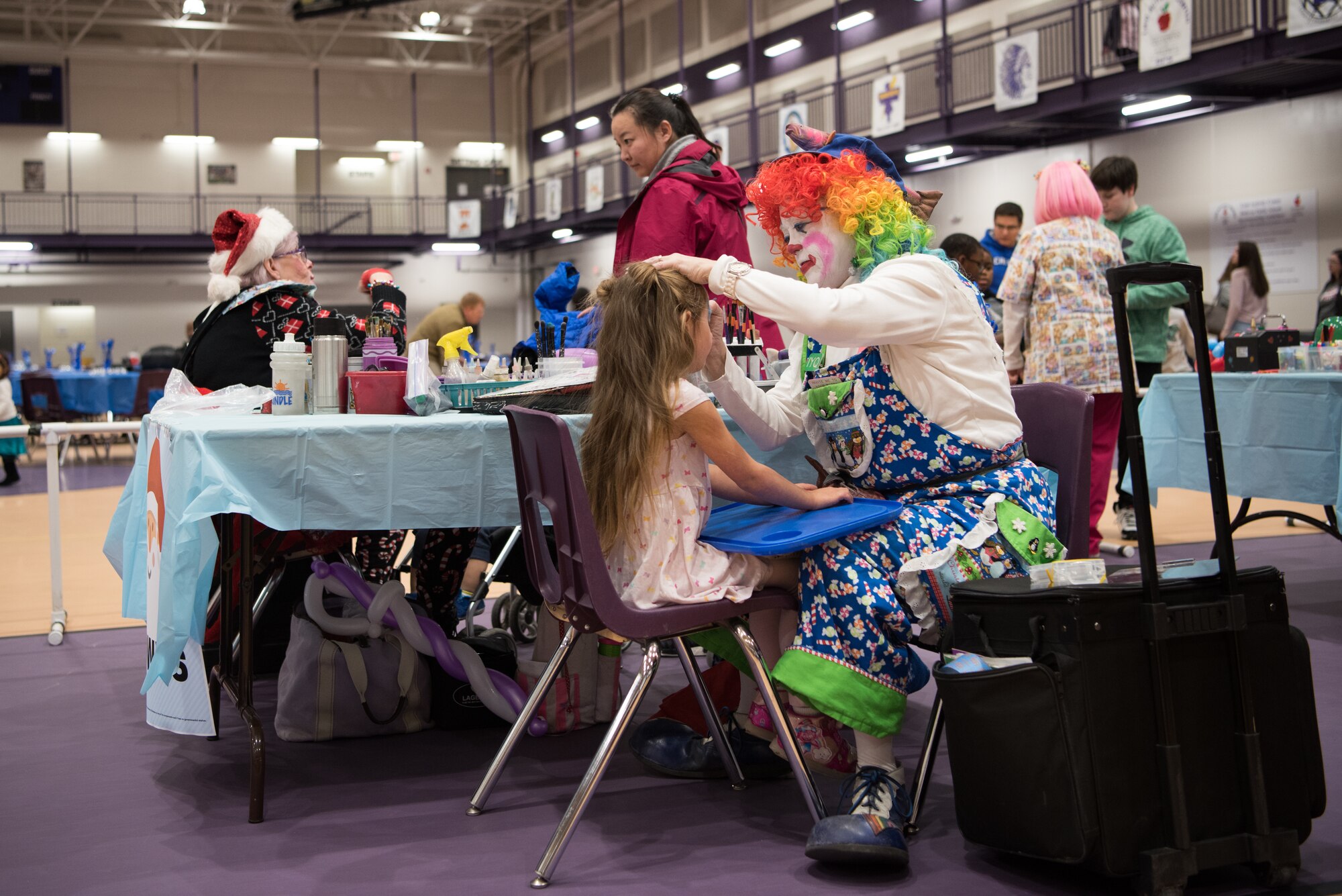 Volunteers at the 25th Annual Winter Wonderland event paint the faces of children Dec. 7, 2018, at the Lied Activity Center in Bellevue, Nebraska. The family focused event was organized, led and ran by the Offutt Enlisted Spouses Club and volunteers. (U.S. Air Force photo by Senior Airman Jacob Skovo)