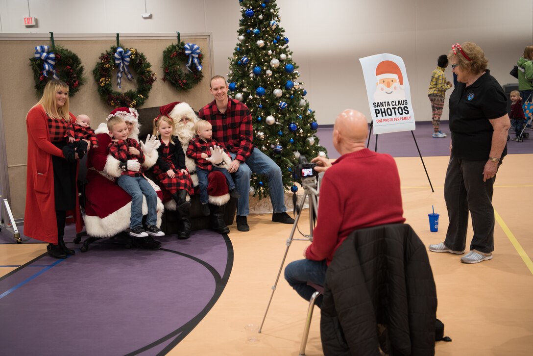 A family has their photo taken with Mr. and Mrs. Claus during the 25th Annual Winter Wonderland event Dec. 7, 2018, at the Lied Activity Center in Bellevue, Nebraska. A team of more than 60 volunteers enabled the event to run smoothly for approximately 800 attendees. (U.S. Air Force photo by Senior Airman Jacob Skovo)