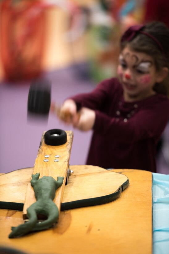A child plays a game during the 25th Annual Winter Wonderland event Dec. 7, 2018, at the Lied Activity Center in Bellevue, Nebraska. The event featured food, crafts, games, clowns, face painting, toys and family photos with Mr. and Mrs. Claus. (U.S. Air Force photo by Senior Airman Jacob Skovo)