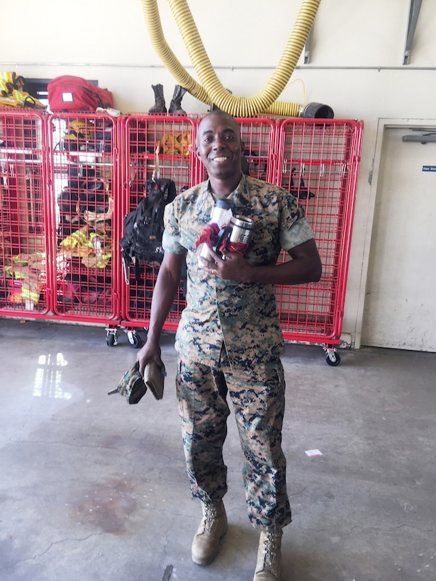 Master Sgt. Darrell D. Wallace, base supply chief, displays the prize basket he won as a result of the Job Hazard Analysis quiz event during the Fire Prevention Barbeque aboard Marine Corps Logistics Base Barstow, Calif., Oct. 11.