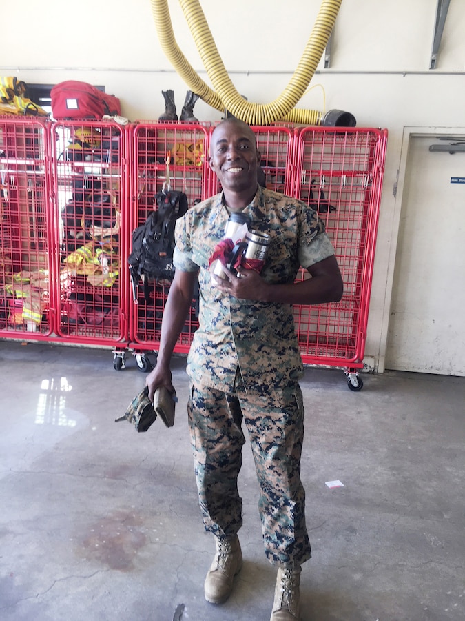 Master Sgt. Darrell D. Wallace, base supply chief, displays the prize basket he won as a result of the Job Hazard Analysis quiz event during the Fire Prevention Barbeque aboard Marine Corps Logistics Base Barstow, Calif., Oct. 11.