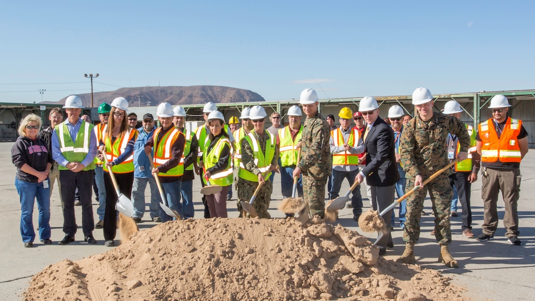 (Right to left) Colonel Craig C. Clemans, Base Commander MCLBB, Chip Schwartz, Production Plant manager, Col. Eric Livingston, Marine Depot Maintenance Command Commander, Lt. Cmdr. Jamie Rivas, Public Works Officer, Stella Madero, Supervisory Contracting Officer, Victor Anaya, Engineering Project Lead and Alicia Florez, Engineering Branch Manager, shovel dirt during the P930 Groundbreaking Ceremony aboard Marine Corps Logistics Base Barstow, Yermo, Calif, Nov. 28.
(U.S. Marine Corps Photo by Jack J Adamyk)