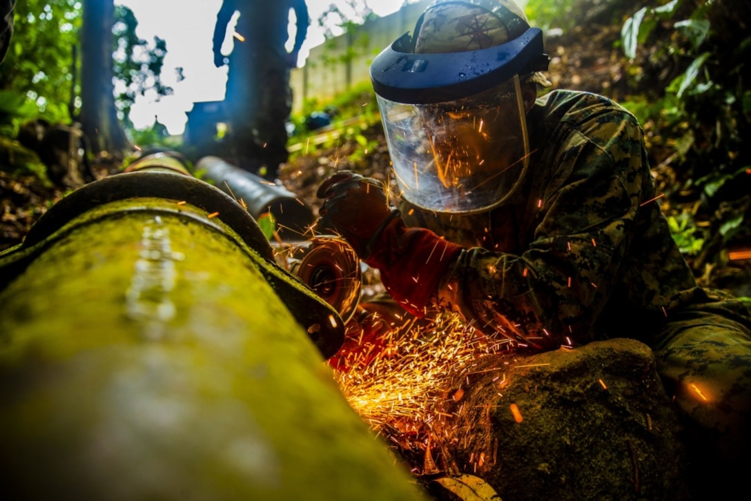 U.S. Marine Staff Sgt. Immanuel Garcia, a metal worker with Special Purpose Marine Air-Ground Task Force - Southern Command, begins cutting sections of a broken water pipe in Trujillo, Honduras, Sept. 19, 2018. The water valve was stuck at 80 percent shut-off, affecting six local communities containing roughly 8,000 people. The Marines repaired the pipe to return water to the local communities. The Marines and sailors of SPMAGTF-SC are conducting security cooperation training and engineering projects alongside partner nation military forces in Central and South America. The unit is also on standby to provide humanitarian assistance and disaster relief in the event of a hurricane or other emergency in the region. (U.S. Marine Corps photo by Sgt. Justin M. Smith)