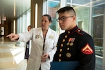 Dr. Rebecca Taylor, Defense POW/MIA Accounting Agency (DPAA) anthropologist, briefs U.S. Marine Corps Lance Cpl. Kenneth Henson during a tour of the DPAA facility at Joint Base Pearl Harbor-Hickam, Hawaii, Nov. 9, 2018. Henson visited the DPAA Laboratory to collect the remains of his grand uncle-in-law, U.S. Army Cpl. Albert Mills, who was a member of Company F, 2nd Battalion 5th Cavalry Regiment, 1st Cavalry Division during the Korean War. Henson served as the special escort for Mills’ remains during transport to final resting place in Dallas. DPAA conducts global search, recovery and laboratory operations to provide the fullest possible accounting for our missing personnel to their families and the nation. (U.S. Air Force photo by Tech. Sgt. Kathrine Dodd)