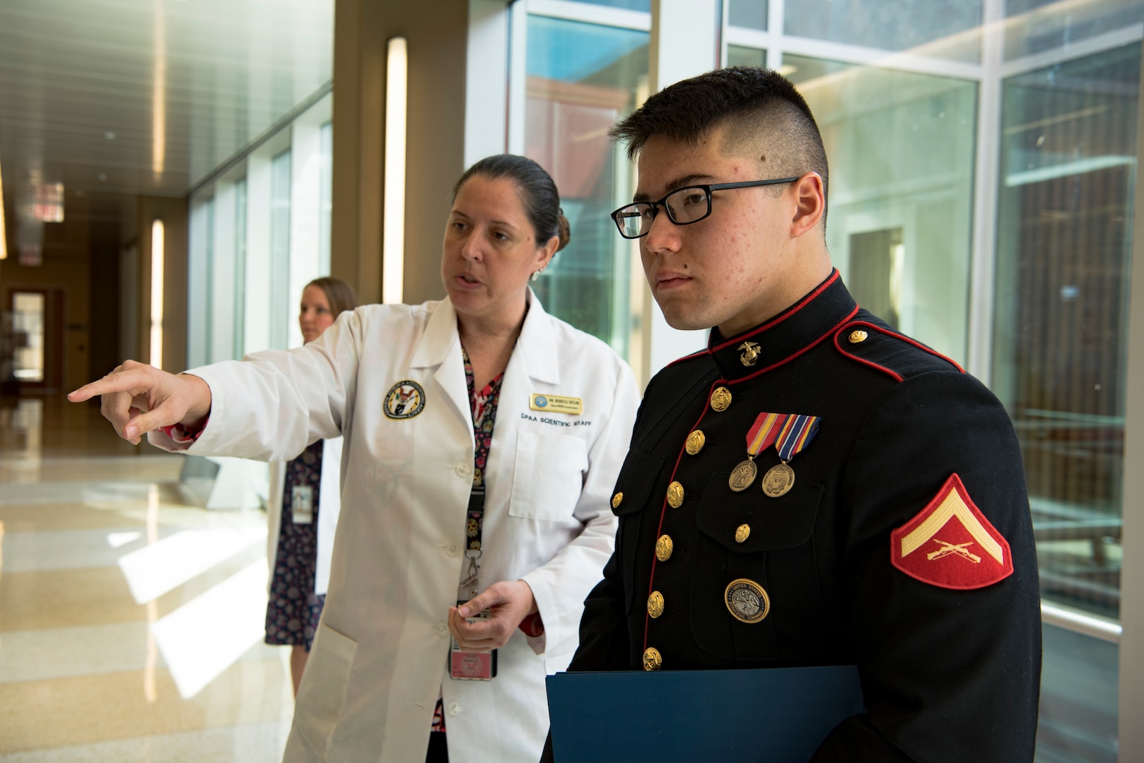 Dr. Rebecca Taylor, Defense POW/MIA Accounting Agency (DPAA) anthropologist, briefs U.S. Marine Corps Lance Cpl. Kenneth Henson during a tour of the DPAA facility at Joint Base Pearl Harbor-Hickam, Hawaii, Nov. 9, 2018. Henson visited the DPAA Laboratory to collect the remains of his grand uncle-in-law, U.S. Army Cpl. Albert Mills, who was a member of Company F, 2nd Battalion 5th Cavalry Regiment, 1st Cavalry Division during the Korean War. Henson served as the special escort for Mills’ remains during transport to final resting place in Dallas. DPAA conducts global search, recovery and laboratory operations to provide the fullest possible accounting for our missing personnel to their families and the nation. (U.S. Air Force photo by Tech. Sgt. Kathrine Dodd)