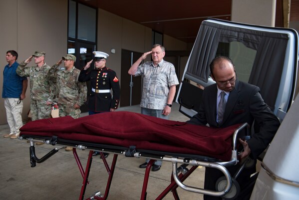Members of the Defense POW/MIA Accounting Agency (DPAA) render honors as a mortician from a local funeral home prepares the remains of U.S. Army Cpl. Albert Mills for transport at Joint Base Pearl Harbor-Hickam, Hawaii, Nov. 9, 2018. Mills, who was a member of Company F, 2nd Battalion 5th Cavalry Regiment, 1st Cavalry Division during the Korean War, was recently identified by the DPAA Laboratory and to rest in his hometown of Dallas. DPAA conducts global search, recovery and laboratory operations to provide the fullest possible accounting for our missing personnel to their families and the nation. (U.S. Air Force photo by Tech. Sgt. Kathrine Dodd)