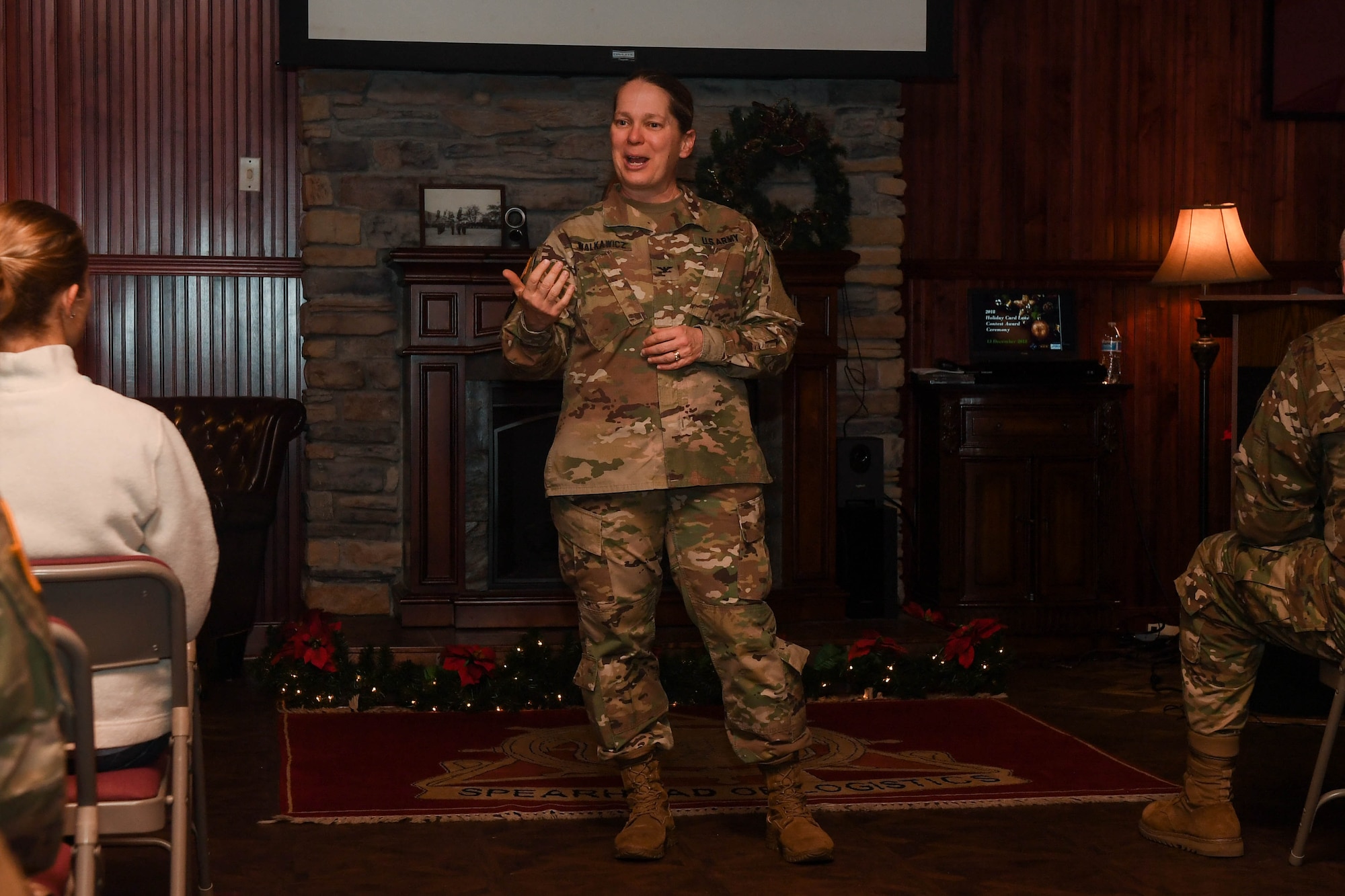 U.S. Army Col. Jennifer Walkawicz, 733rd Mission Support Group commander, speaks to attendees and participants of the Holiday Card Lane contest at Joint Base Langley-Eustis, Virginia, Dec. 13, 2018. The contest allowed units across the installation to create large holiday cards that are displayed on the U.S. Transportation Museum fence. (U.S. Air Force photo by Senior Airman Derek Seifert)