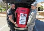 Jason Wheeler, 359th Medical Operations Squadron physical therapist, left, and 2nd Lt. Michael Ehlen, 12th Training Squadron student pilot, place a container of nonperishable food items into a vehicle for eventual transport to the San Antonio Food Bank Dec. 10, 2018, at Joint Base San Antonio-Randolph. The 359th MDOS Physical Therapy Flight is leading two drives during the holiday season: One of them will benefit the San Antonio Food Bank, while the other will provide relief to the victims of Hurricane Michael.