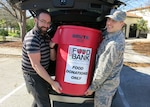 Jason Wheeler, 359th Medical Operations Squadron physical therapist, left, and 2nd Lt. Michael Ehlen, 12th Training Squadron student pilot, place a container of nonperishable food items into a vehicle for eventual transport to the San Antonio Food Bank Dec. 10, 2018, at Joint Base San Antonio-Randolph. The 359th MDOS Physical Therapy Flight is leading two drives during the holiday season: One of them will benefit the San Antonio Food Bank, while the other will provide relief to the victims of Hurricane Michael.