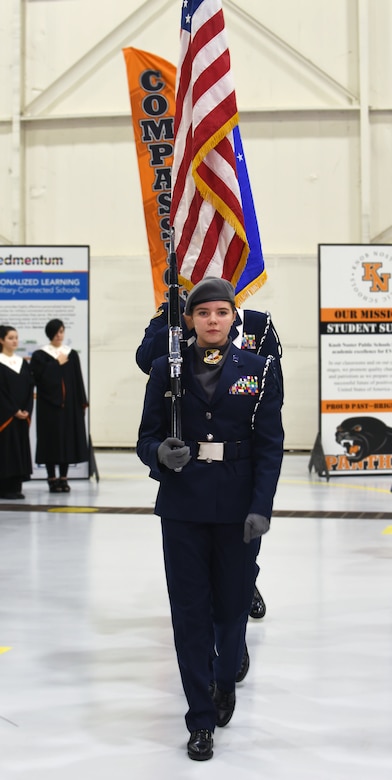Knob Noster High School Air Force JROTC Cadet Maj. Chloe McDonnell leads a color guard formation at the beginning of a ceremony.