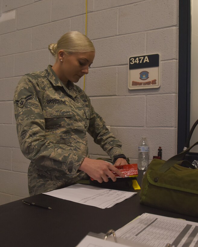 U.S Air Force Airman 1st Class Maggie Breedlove, 317th Operational Support Squadron aircrew flight equipment apprentice, inspects Emergency Passenger Oxygen Systems at Dyess Air Force Base, Texas, Dec. 12, 2018. Every week, the AFE shop has to inspect over 300 individual EPOS units to ensure they function correctly. (U.S. Air Force photo by Airman 1st Class Rebecca Van Syoc)