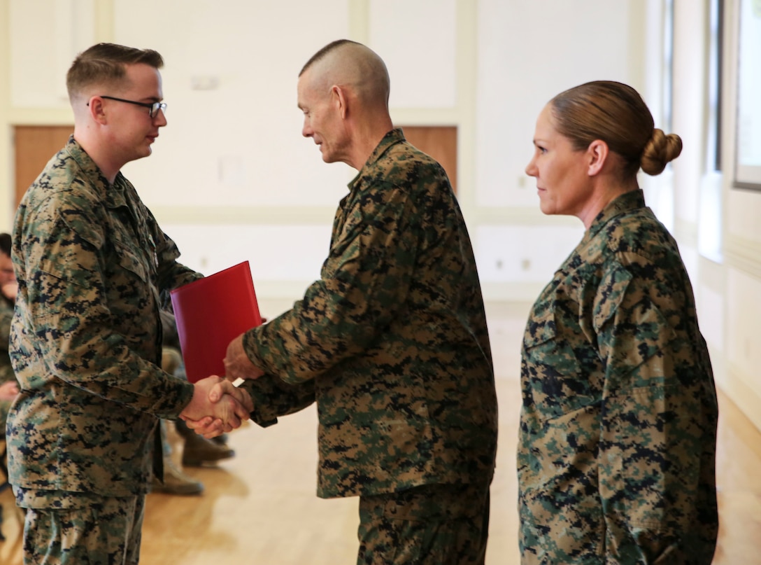 U.S. Marine Corps Brig. Gen. Stephen M. Neary, commanding general of 2nd Marine Expeditionary Brigade, presents a Navy and Marine Corps Achievement Medal to Cpl. Jordan Deisler, a 2nd MEB administrative specialist, at Camp Lejeune, N.C., Dec. 11, 2018. Deisler received the award for his exemplary performance while supporting the unit during Exercise Trident Juncture 18 in Norway. The award is earned by exemplifying superior performance outside one’s designated military occupational specialty. (U.S. Marine Corps photo by Cpl. Patrick Osino)