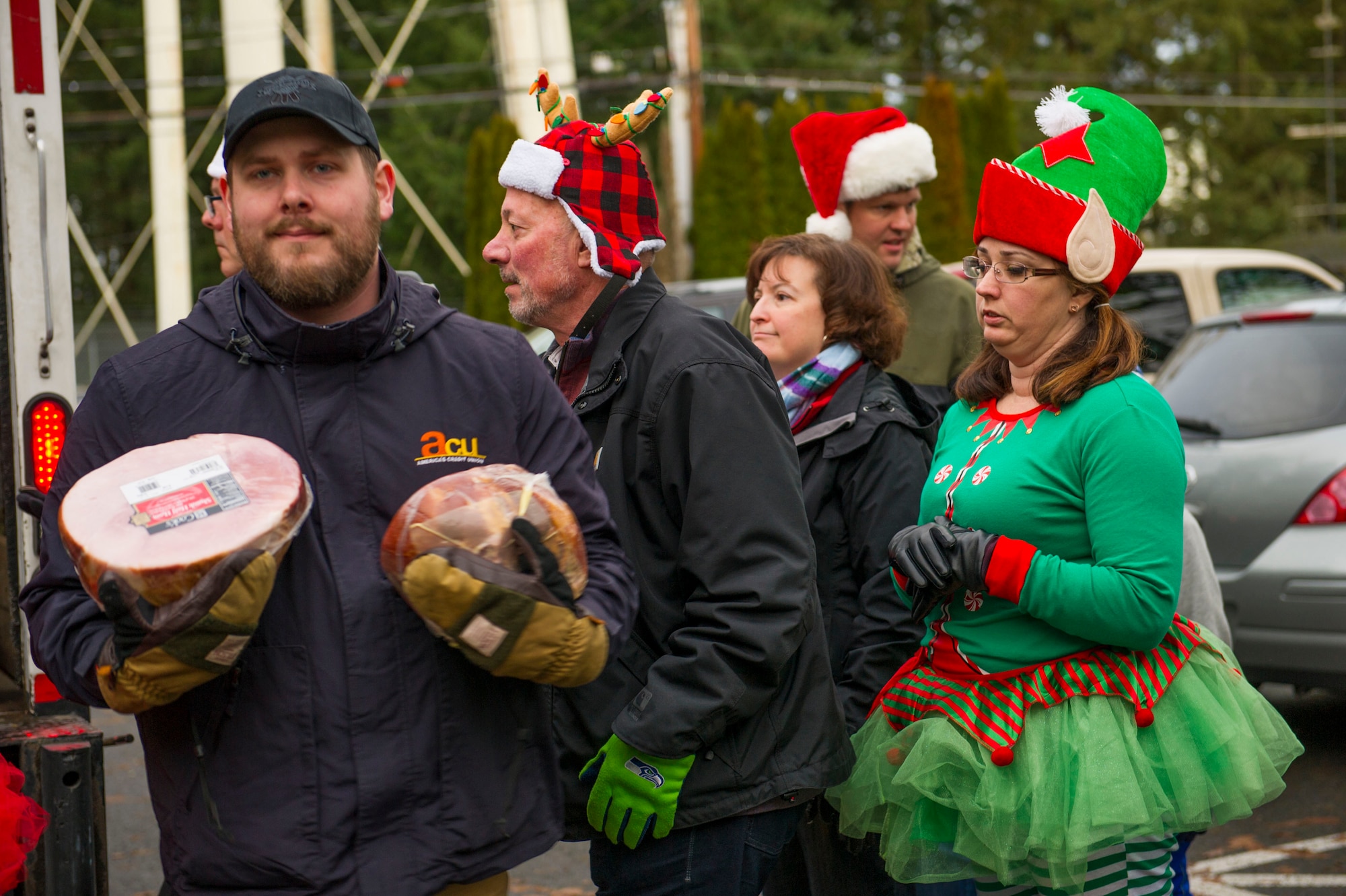 Community members help deliver hams Dec. 12 as part of Operation Ham Grenade. The 9th Annual Operation Ham Grenade brought 20 local community members and volunteers dressed up as elves and Santa’s helpers to deliver complimentary hams to Reserve Citizen Airmen. (U.S. Air Force photo by Staff Sgt. Mary Andom)