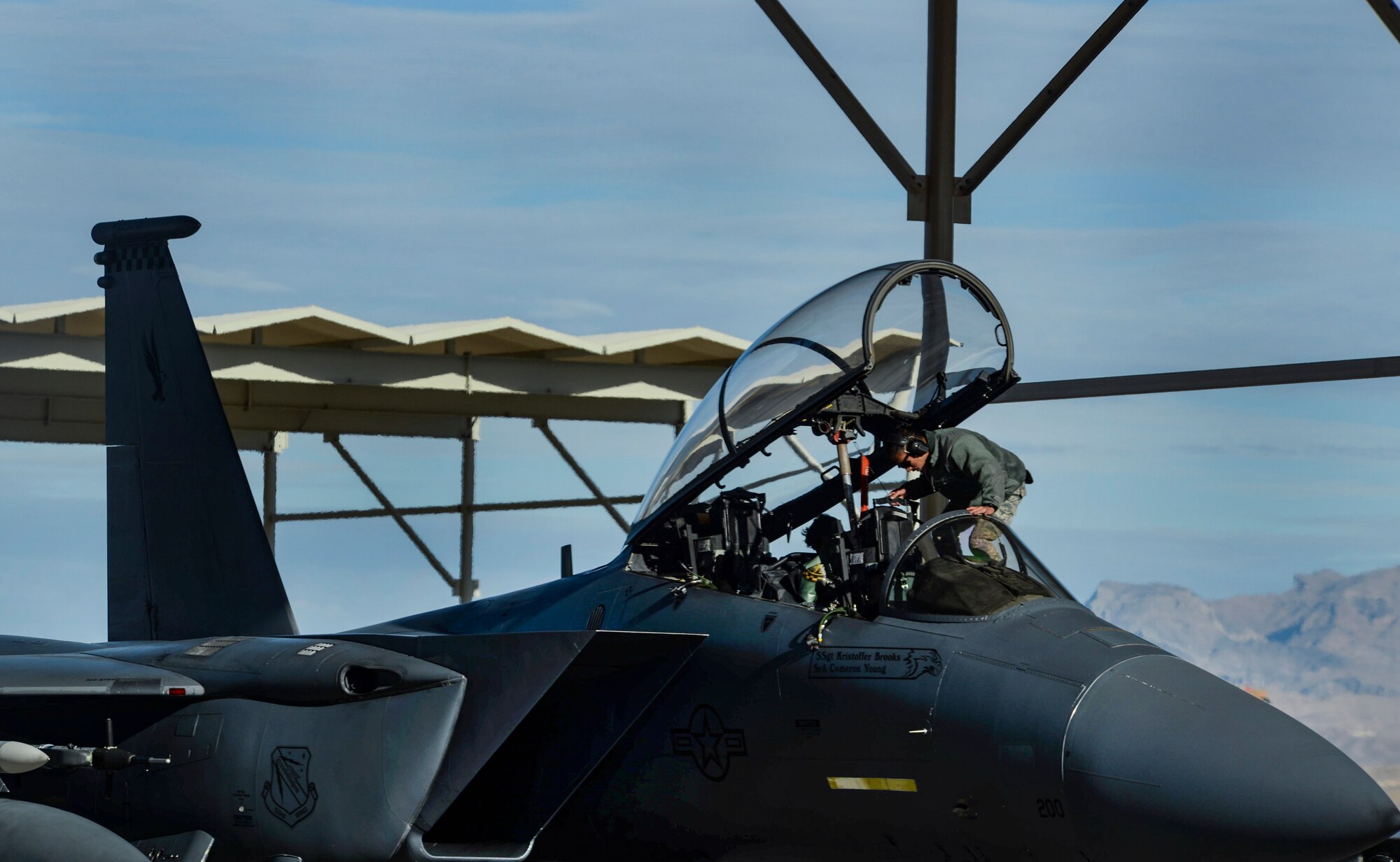 Airman 1st Class Bonifacio Garcia, 757th Aircraft Maintenance Squadron Strike Aircraft Maintenance Unit F-15E Strike Eagle fighter jet maintainer, prepares an F-15E for launch during the Weapons School Integration (WSINT) Dec. 4, 2018 at Nellis Air Force Base, Nevada. WSINT is a two-week series of complex, large-force employment missions. (U.S. Air Force photo by Airman 1st Class Bailee A. Darbasie)