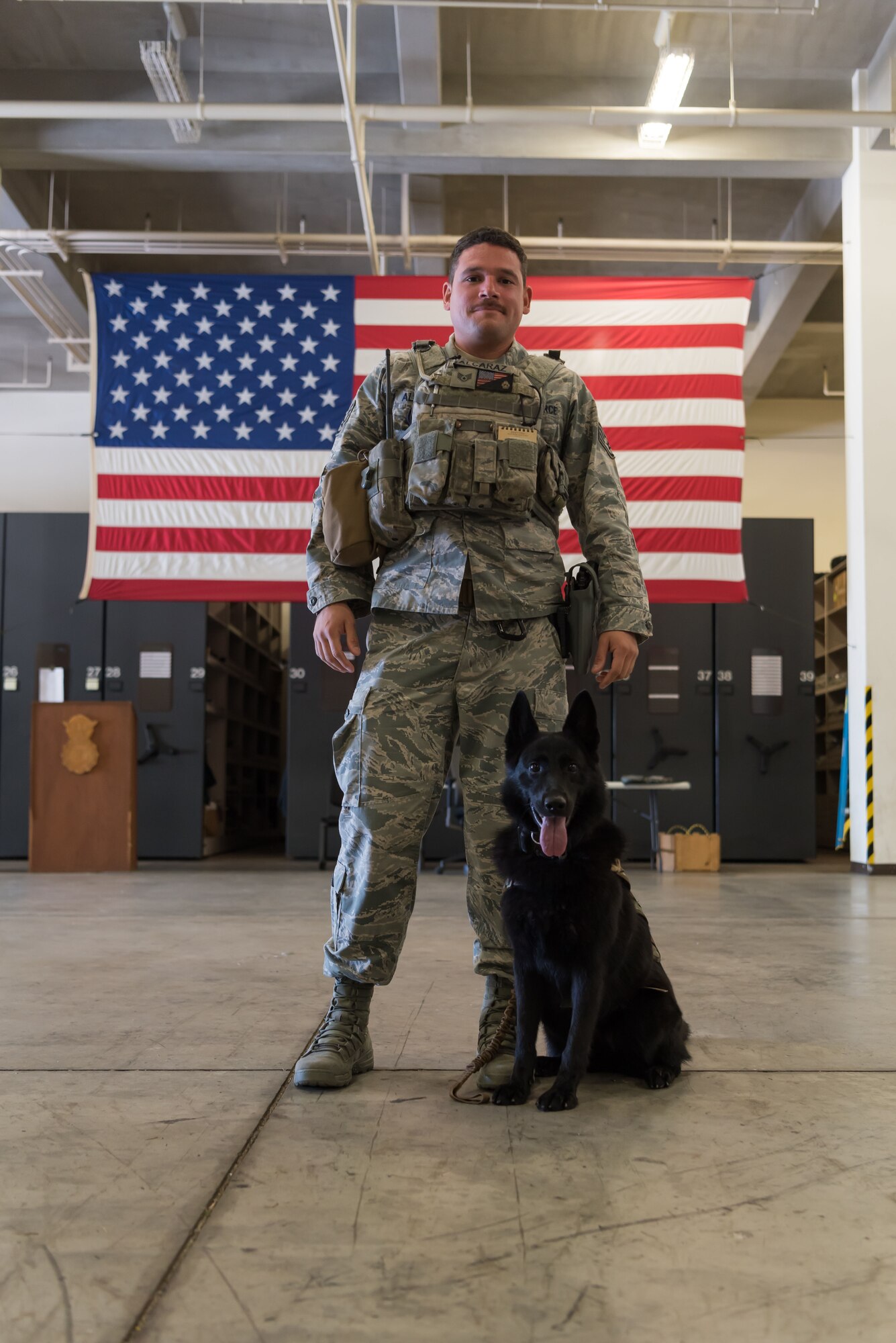 U.S. Air Force Staff Sgt. Eduardo Alcaraz, 18th Security Forces Squadron military working dog handler, and his military working dog, Sony, pose for a photo Nov. 21, 2018, at Kadena Air Base, Japan. The bond between a military working dog and its handler is founded on trust, and can become unbreakable within their time together.