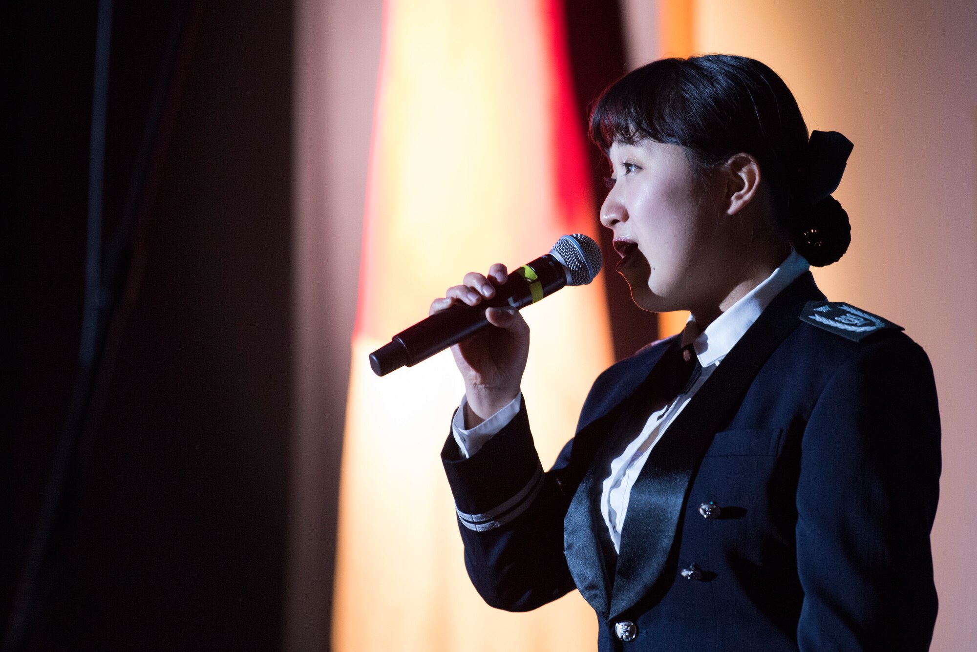 Japan Air Self Defense Force Airman 2nd Class Saki Morita, JASDF Central Band vocalist, sings the Japanese national anthem during Sounds of the Season, Dec. 12, 2018, at Yokota Air Base, Japan.