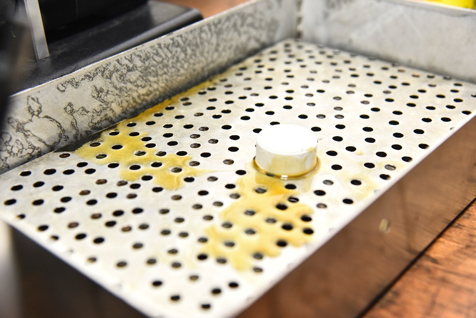 Standard oil sits in a catch tray in the 380th Expeditionary Maintenance Squadron Non-Destructive Inspection shop at Al Dhafra Air Base, United Arab Emirates, Dec. 7, 2018. The NDI shop uses certain techniques, including fluorescent penetrant inspections and special oil analyses. These are some of the numerous methods used to repair, diagnose or prevent damage to the aircraft, its oil, and the parts. (U.S. Air Force photo by Senior Airman Mya M. Crosby)