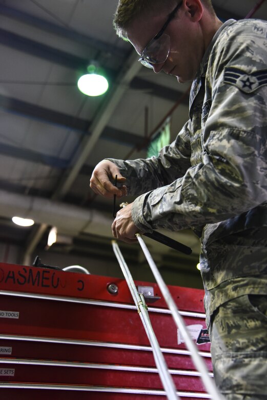 U.S. Air Force Senior Airman Steven Schwab, 380th Expeditionary Maintenance Squadron aircraft structural repair technician, uses a hand tubing cutting tool at Al Dhafra Air Base, United Arab Emirates, Dec. 9, 2018. The 380th EMXS fabrication flight is in charge of identifying and repairing aircraft structural damage. (U.S. Air Force photo by Senior Airman Mya M. Crosby)
