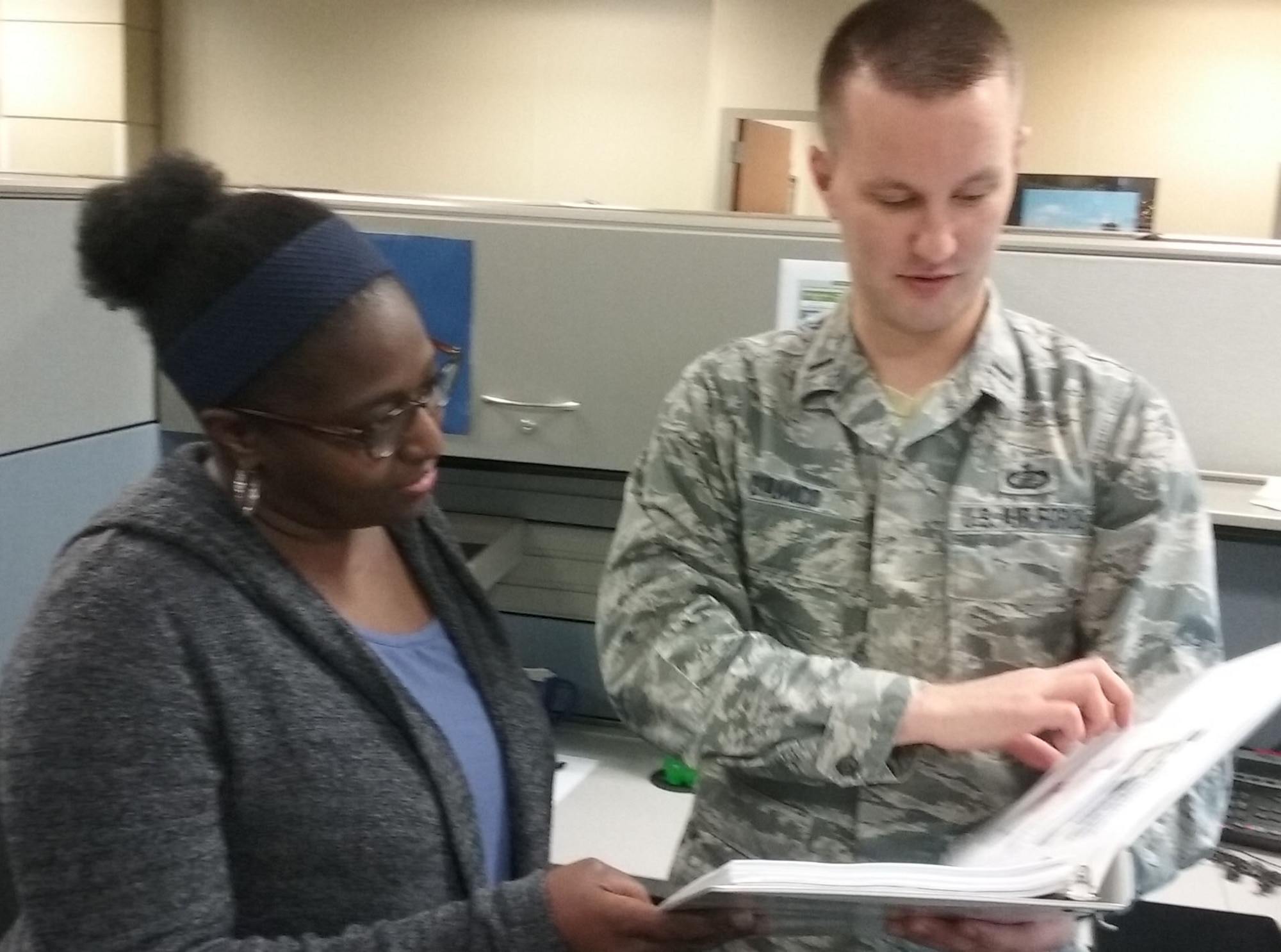 Paula Boykin and 1st Lt. Cory D'Amico review policy to increase Government Travel Card spending limits for people who evacuated from Tyndall Air Force Base due to Hurricane Michael. (U.S. Air Force Photo by Ed Shannon)