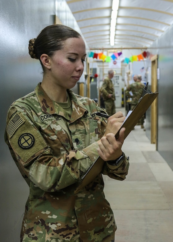 U.S. Army Spc. Katelyn Conn, a healthcare specialist with Headquarters and Headquarters Company, 1-108th Assault Helicopter Battalion, a Kansas Army National Guard unit headquartered in Topeka, Kansas, takes notes following a patient intake at the 935th Aviation Support Battalion combined aid station, Camp Buehring, Kuwait, Dec. 10, 2018.  The CAS provided level-two medical care to U.S. Soldiers assigned to the 35th Combat Aviation Brigade.