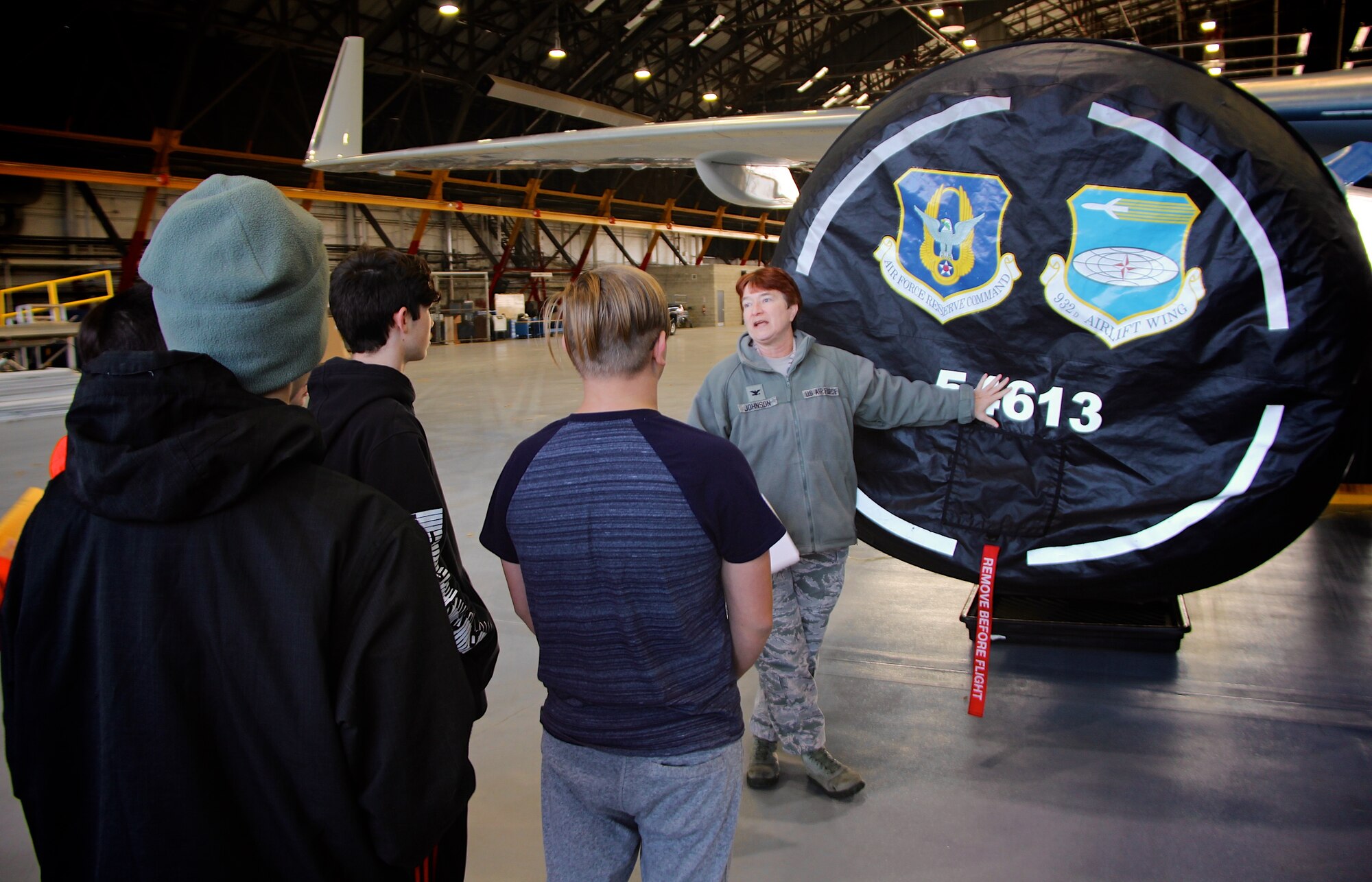As part of a community outreach event, the 932nd Airlift Wing Maintenance Group's top officer and commander, Col. Sharon Johnson, talks about the C-40 plane, the Air Force Reserve and the 932nd Airlift Wing, to a group of eighth grade Science, Technology, Engineering, and Mathematics (STEM) students.  The students visited December 10, 2018, at Scott Air Force Base, Illinois. Johnson's group of Airmen maintain four of the C-40 aircraft belonging to the 932nd AW and operated by the 932nd Operations Group and updated by the 932nd Maintenance Group.  She and the public affairs officer escorted local Mascoutah students out to their hangar work center, to see more about how an airplane engine, wheels, tires, hydraulics, and wings work together and get a plane off the ground. Johnson and her maintainers manned informational stations as multiple groups of students rotated through various areas every 45 minutes at the reserve unit, located in southern Illinois near Belleville. (U.S. Air Force photo by Lt. Col. Stan Paregien)