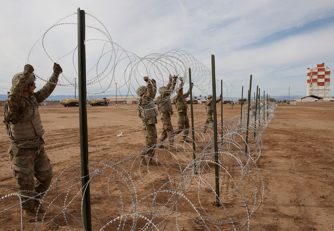 U.S Soldiers with 541st Engineer Company, Special Purpose Marine Air-Ground Task Force 7, position concertina wire on a practice barricade at Naval Air Facility El Centro in California, Dec. 4, 2018. U.S. Northern Command is providing military support to the Department of Homeland Security and U.S. Customs and Border Protection to secure the Southern border of the United States. (U.S. Marine Corps photo by Sgt. Asia J. Sorenson)