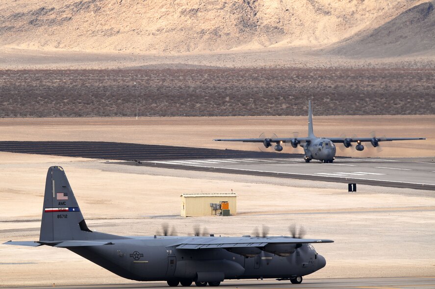 Two C-130 Hercules taxi the airfield at Creech Air Force Base, Nevada, Dec. 10, 2018. As one of the most challenging and complex missions of the year, Joint Forcible Entry exercise integrates decisive action and demonstrates crisis response as well as global mobility. (U.S. Air Force Photo by Senior Airman James Thompson)