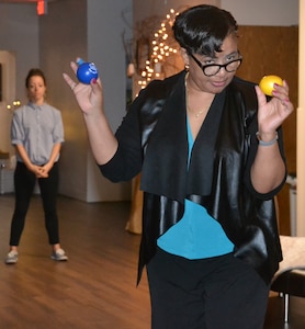 Darlene Taylor, Suicide Prevention Program manager at the Vogel Resiliency Center at Joint Base San Antonio-Fort Sam Houston, demonstrates how stress balls can be used to relieve stress during “The Gift of Presence: Resiliency Reset” event at the center Nov. 30.