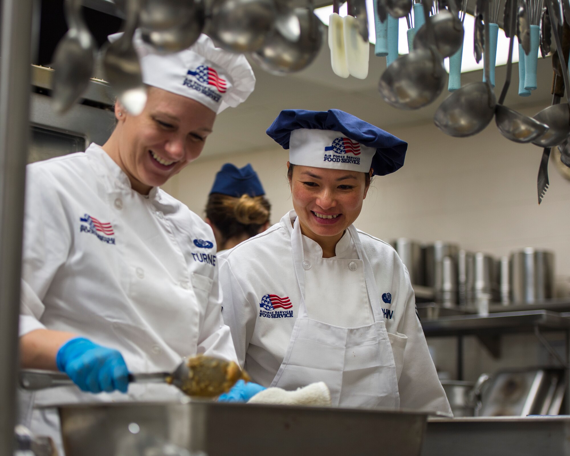 U.S. Air Force Staff Sgt. Janna Turner, left, and Airman 1st Class Dieu-Huyen Johnson, 133rd Force Support Squadron, Sustainment Services Flight, prep food for the Wing holiday meal at the dining facility in St. Paul, Minn., Nov. 11, 2018.