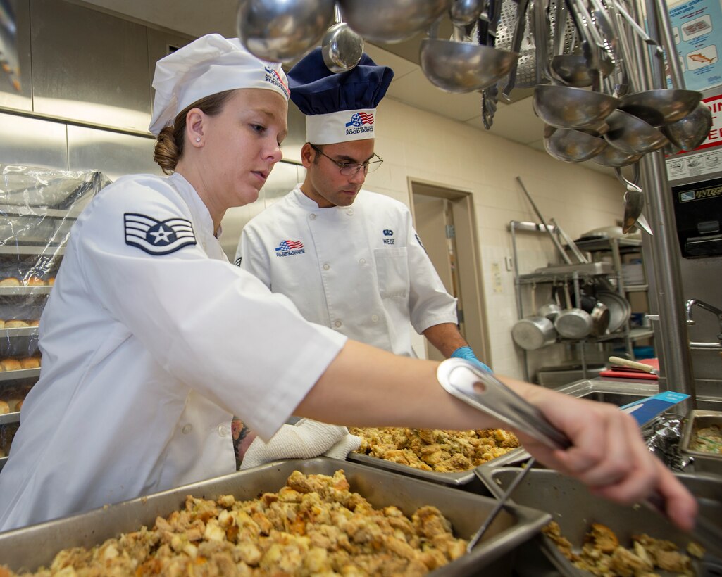 U.S. Air Force Staff Sgt. Janna Turner, left, and Senior Airman Christopher Weise, 133rd Force Support Squadron, Sustainment Services Flight, prep food for the Wing holiday meal at the dining facility in St. Paul, Minn., Nov. 11, 2018.