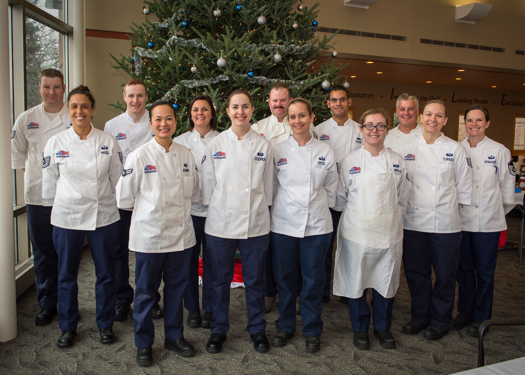 U.S. Air Force Airmen from the 133rd Force Support Squadron, Sustainment Services Flight, pose for a group photo after prepping food for the Wing holiday meal at the dining facility in St. Paul, Minn., Nov. 11, 2018.