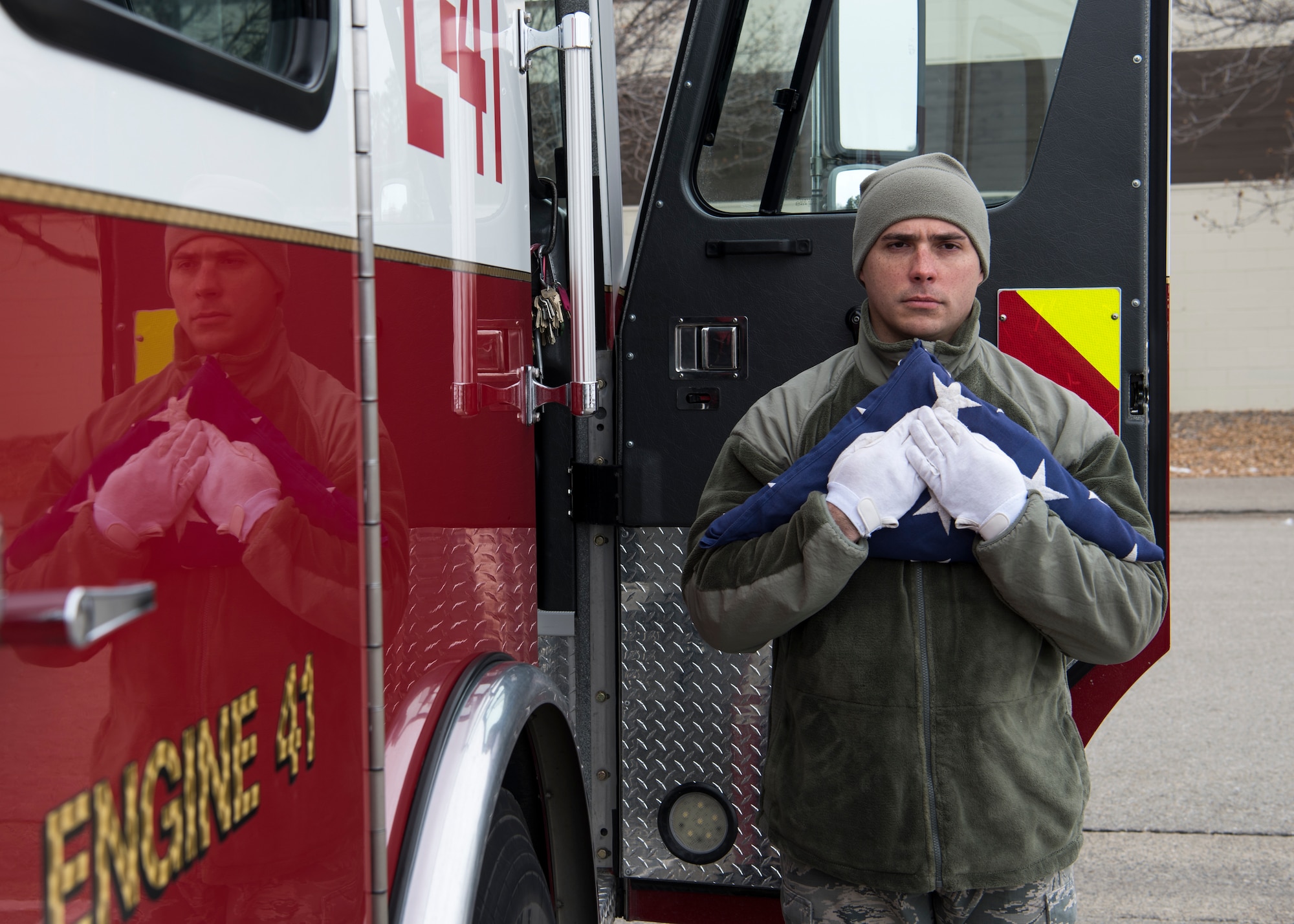 Airman 1st Class Adam Okula, 366th Fighter Wing base ceremonial guardsman, carries a flag from a fire truck during funeral sequence training Dec. 7, 2018, at Mountain Home Air Force Base, Idaho. The U.S. Air Force Honor Guard held a ceremonial guardsman training course Dec. 3-12 to help the base honor guard maintain their skills during multiple member sequence training. (U.S. Air Force photo by Airman 1st Class Andrew Kobialka)