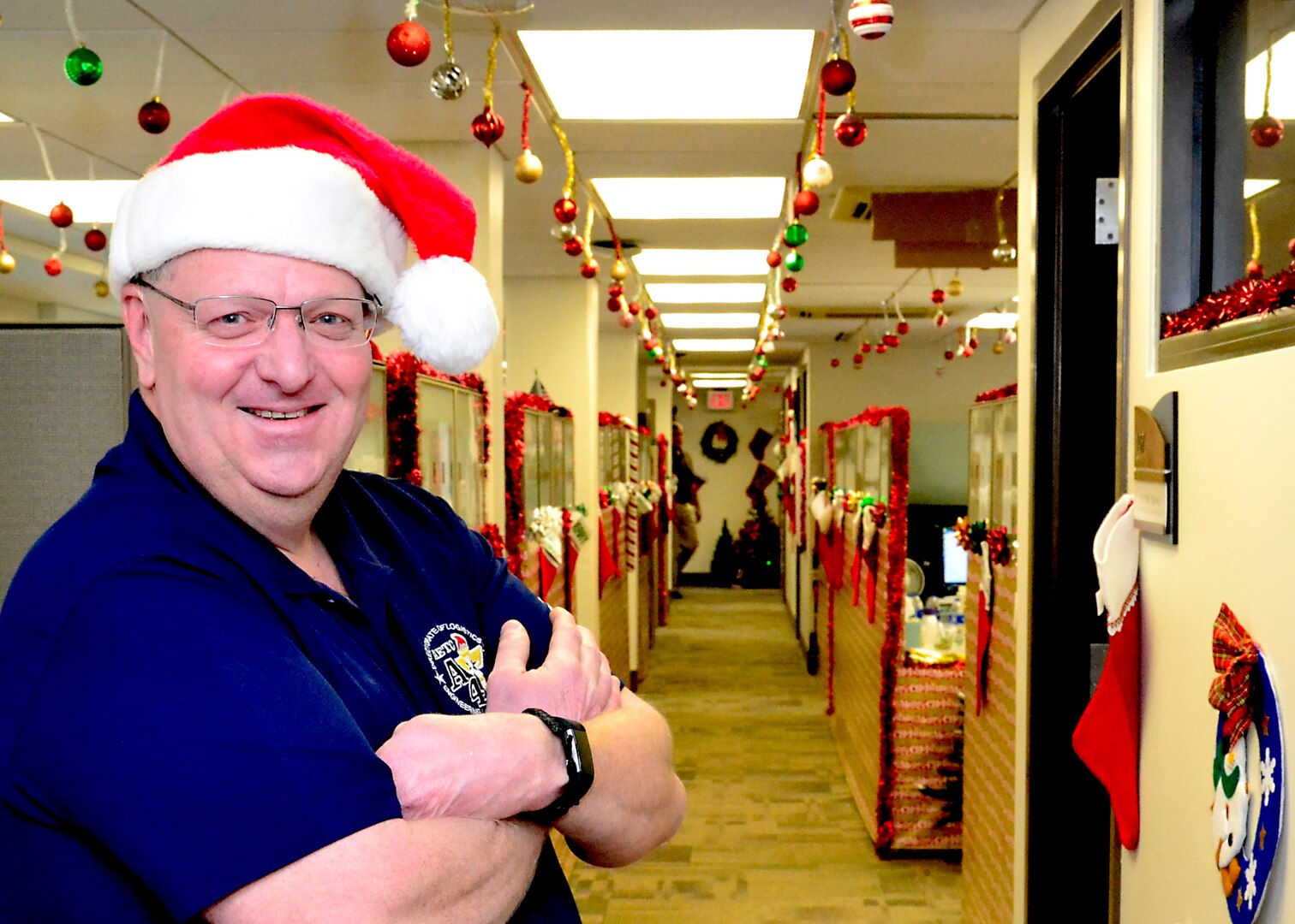 Marc Collette, Headquarters Air Education Training Command, equipment manager, A4R Logistics and Readiness Division, poses with a decorated office as his backdrop, Dec. 4, 2018 at Joint Base San Antonio, Texas. Collette started this tradition after going through a divorce in 1997 to cheer up his children.